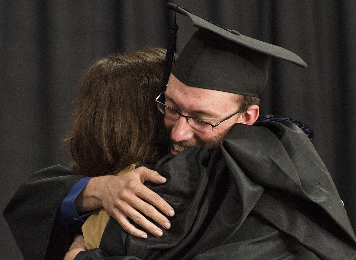 Colorado Mountain College graduate Thomas Schoonover, right, hugs Rachel Pokrandt, vice president and campus dean of CMC Leadville and Chaffee County, as Schoonover receives his associate degree in natural resource management during the campus’s May 4 commencement ceremonies at the Climax Molybdenum Leadership Center at the Leadville campus. Photo Andy Colwell