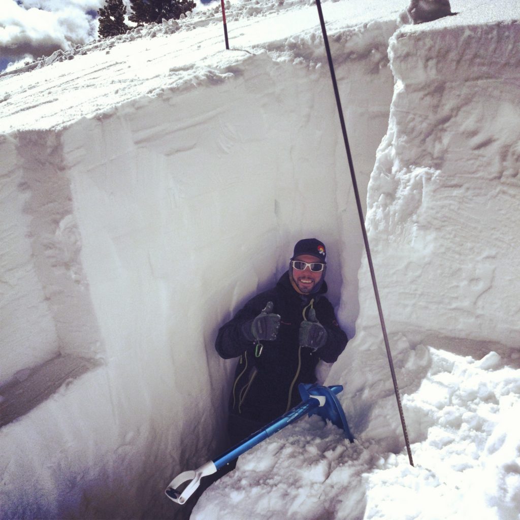 Eric McCue, Ski Patrol for Beaver Creek and Avalanche Science student at Colorado Mountain College, poses for a photo in a snowpit.