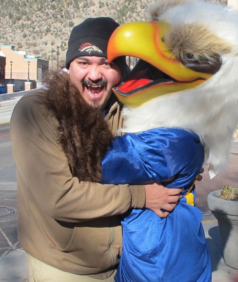 photo: the CMC mascot, Swoop, hugs a man