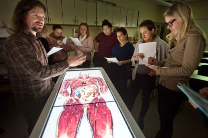 A CMC anatomy faculty demonstrates using an Anatomage display.