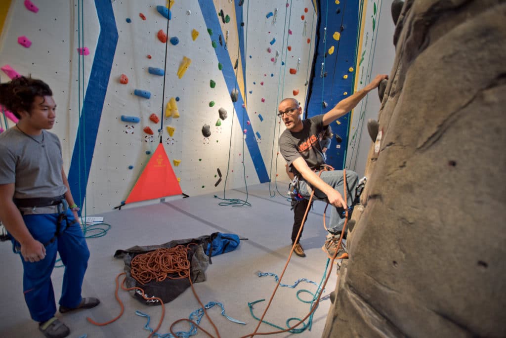 Students and community members work out on the climbing walls of CMC Spring Valley Outdoor Leadership Center & Field House.