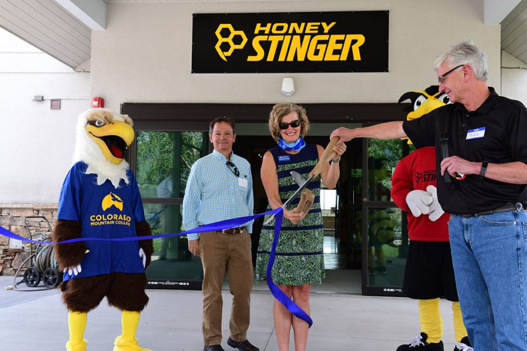 Using physical distancing guidelines, Honey Stinger hosted a ribbon cutting celebration with Colorado Mountain College Steamboat Springs on Aug. 5. Honey Stinger has gifted the college’s Yampa Valley Entrepreneurship Center a large loft space to operate from in Honey Stinger’s new headquarters on Airport Circle. At the ceremony are, from left, CMC’s mascot Swoop the eagle; YVEC Director Randy Rudasics; CMC President and CEO Carrie Besnette Hauser; Honey Stinger’s mascot Buzz the bee, and Honey Stinger CEO Mike Keown. Photo Greg Hughey