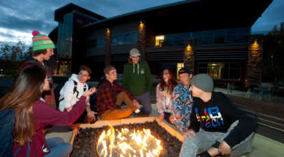 Students around the firepit in front of the CMC Steamboat Springs Academic Center.