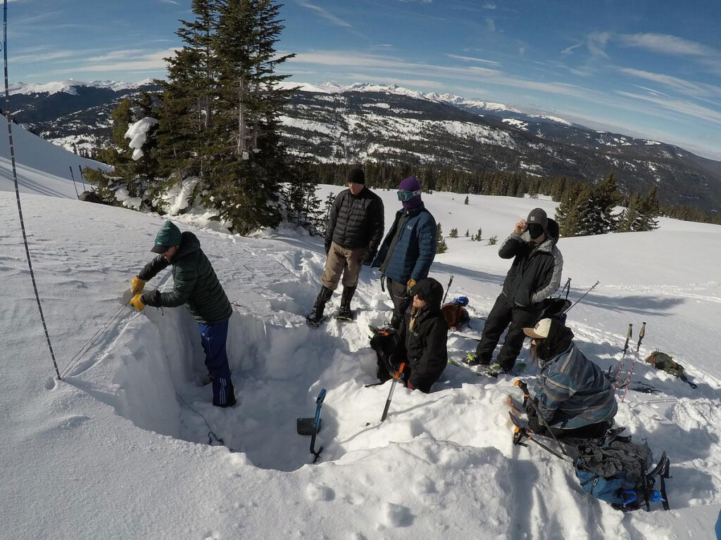 CMC Outdoor Education students dig an avalanche snow pit.