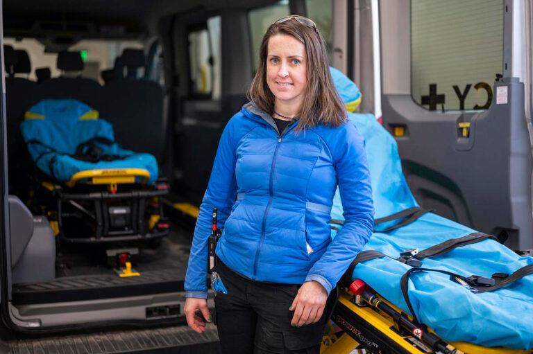 Katie Fielder standing at the back of an ambulance.