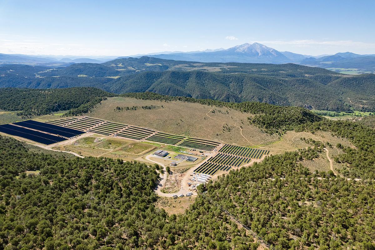An aerial photo of the Spring Valley Solar Array & Battery Storage Complex with Mount Sopris in the background.